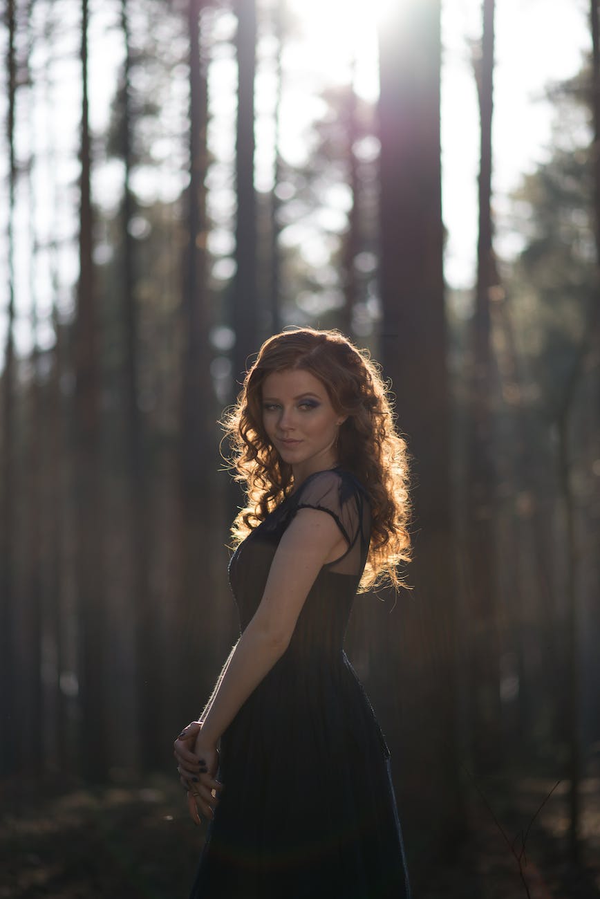 focus photo of woman near trees