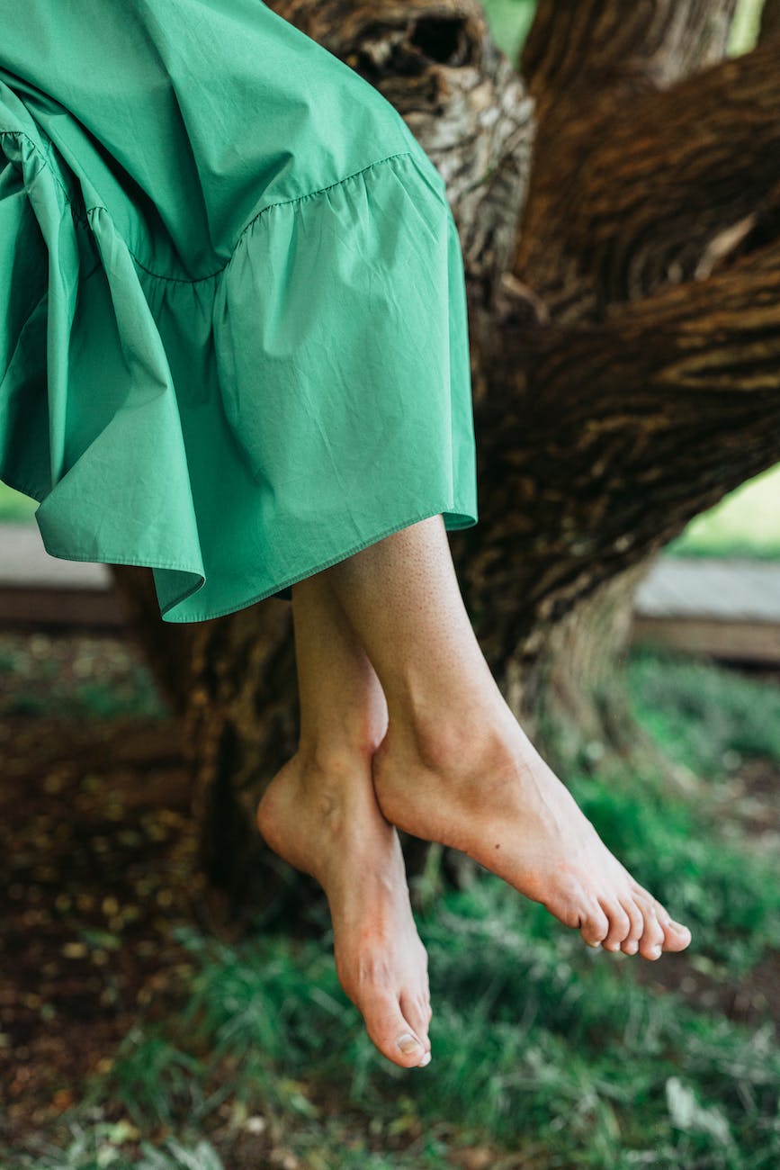 barefooted person wearing green skirt